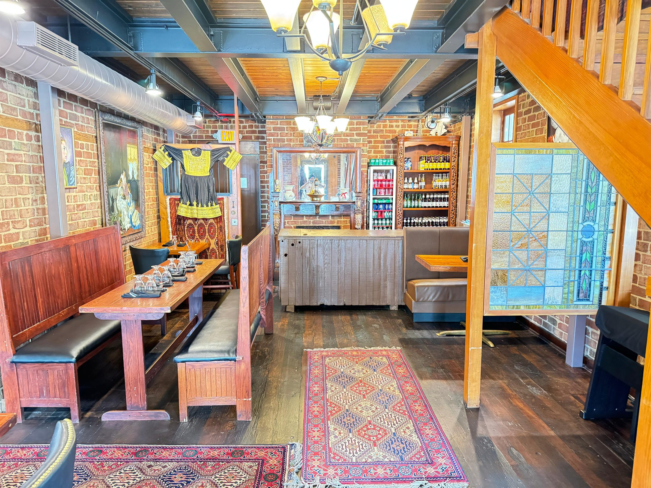 Afghan Kabob House dining room with brick walls, Afghan decor, and set tables